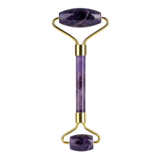 Purple jade roller with gold accents on a white background