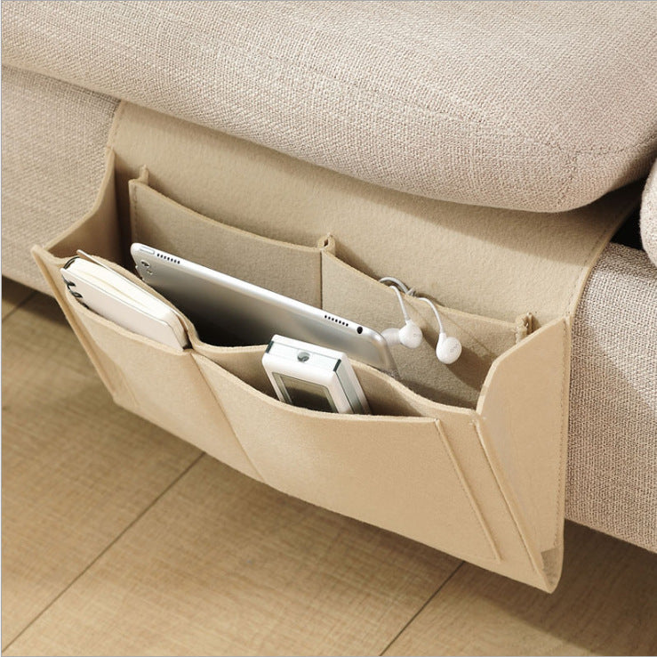 Beige sofa caddy with electronic devices on a beige couch