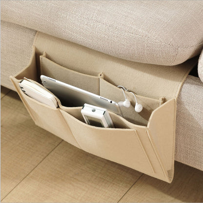 Beige sofa caddy with electronic devices on a beige couch