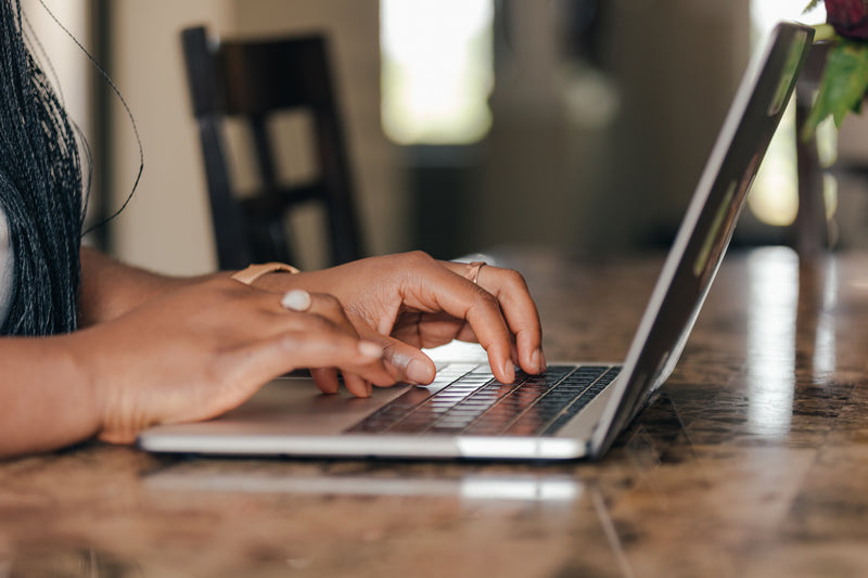 Woman typing on laptop at home, cozy lifestyle setup with smart tech essentials