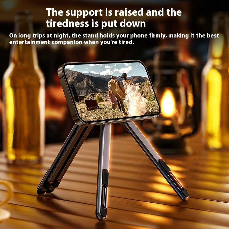 Foldable magnetic multi-device stand holding a smartphone on a desk