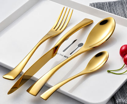 Gold stainless steel cutlery set arranged on a white plate