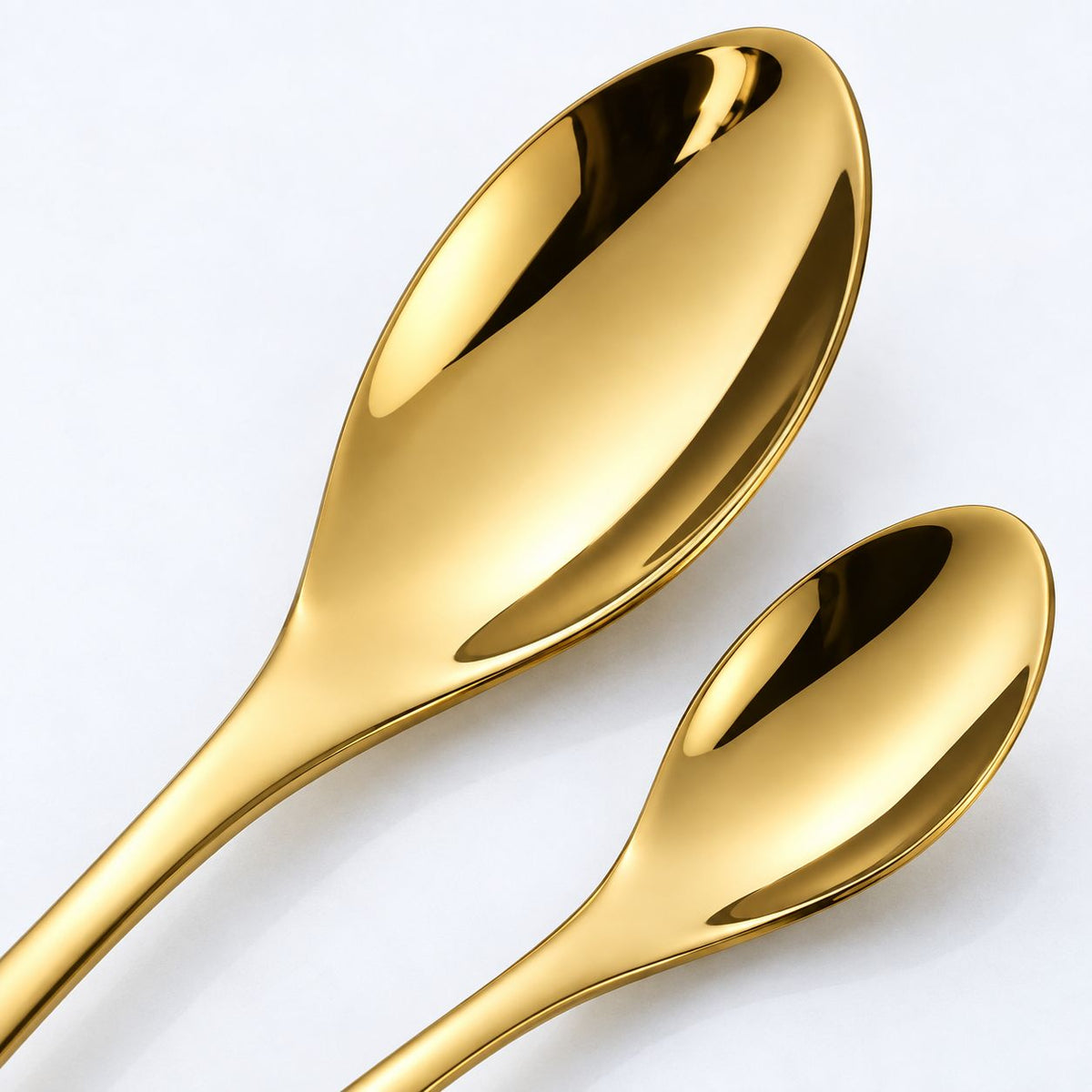 Close-up of gold stainless steel tablespoon and teaspoon