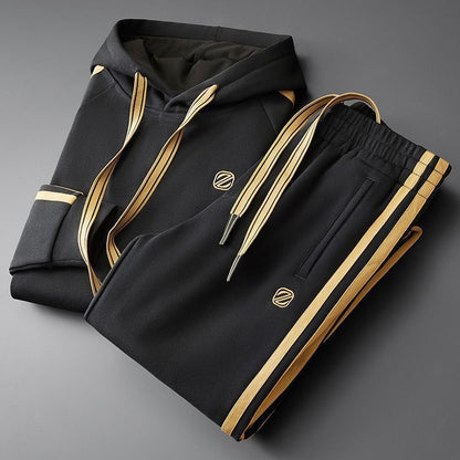Men's hooded two-piece tracksuit set in onyx black with gold contrast details