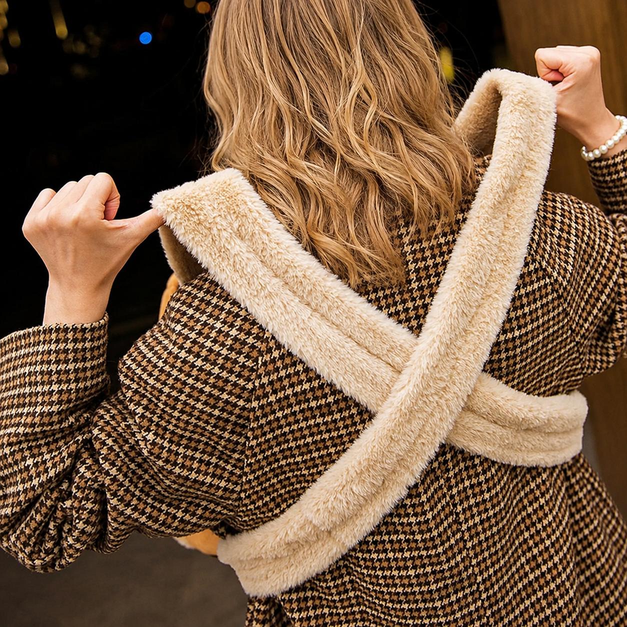 Rear view of a woman wearing a reindeer-themed pet carrier backpack