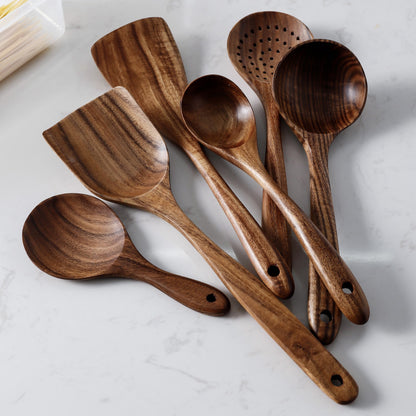 Assorted teak wood spoons, spatulas, and cooking utensils