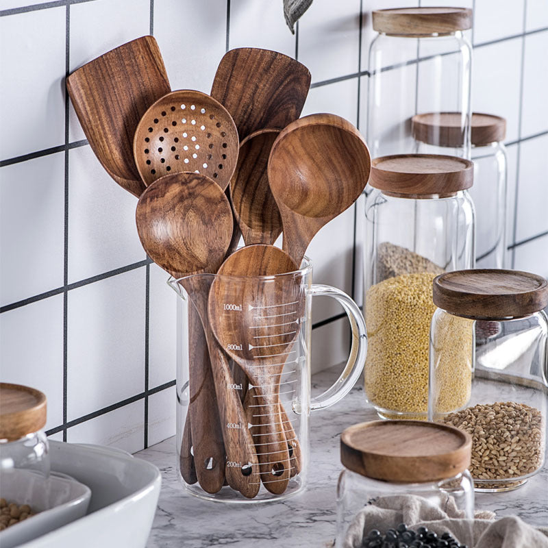 Teak wood kitchen utensils displayed in a kitchen storage holder